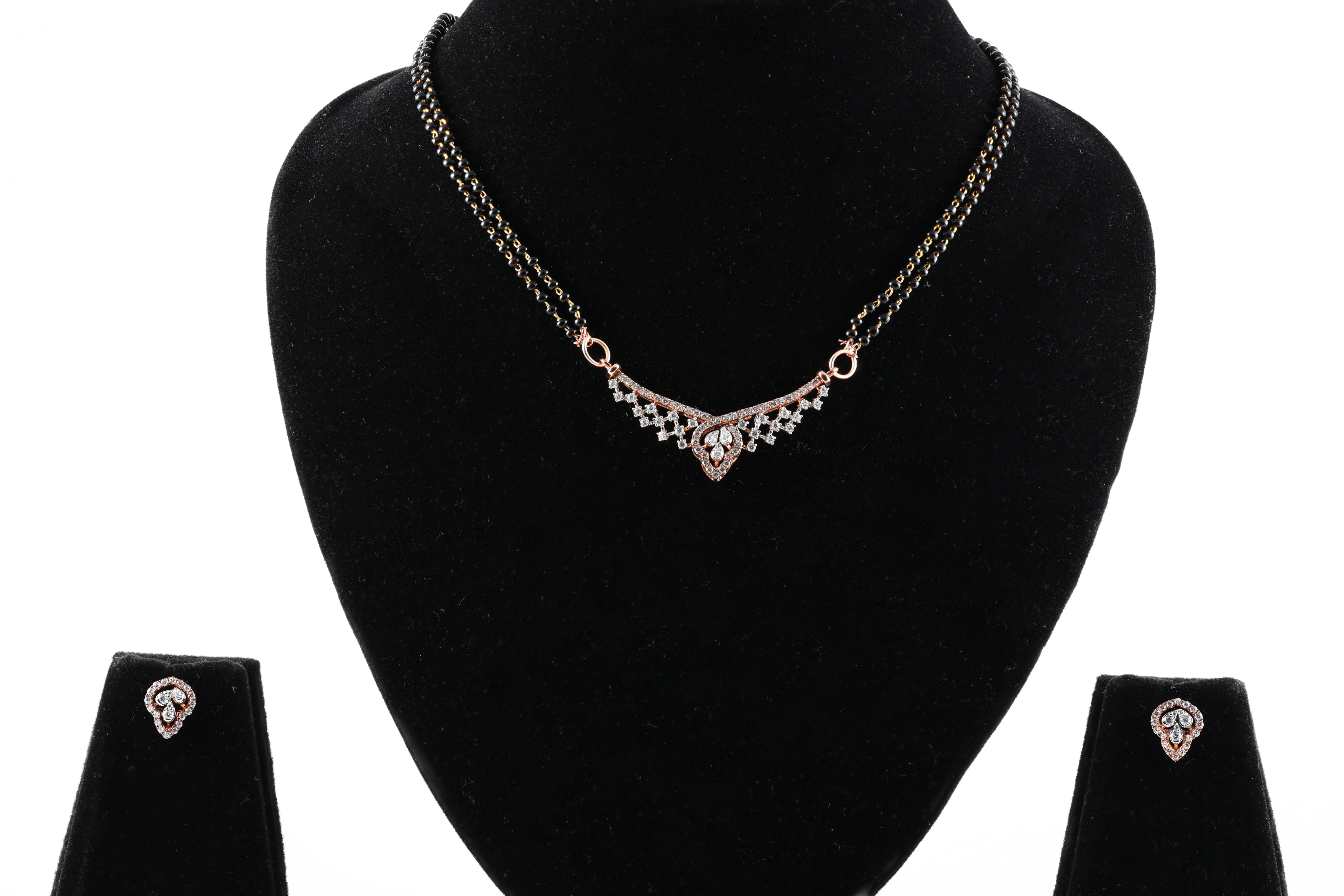 Elegant real Gold diamond mangalsutra set with matching earrings.